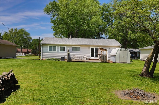 14 Dee St, Moro, IL 62067 - back of house featuring a shed, a wooden deck, an outbuilding, and a lawn