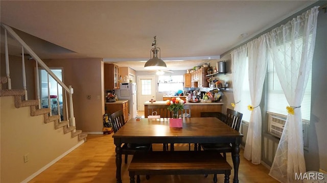 811 N Catalpa St, Dexter, MO 63841 - dining space with stairs, baseboards, light wood-style flooring, and cooling unit
