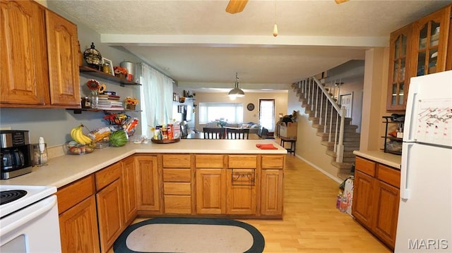 811 N Catalpa St, Dexter, MO 63841 - kitchen featuring white appliances, a peninsula, light wood-style flooring, light countertops, and beamed ceiling