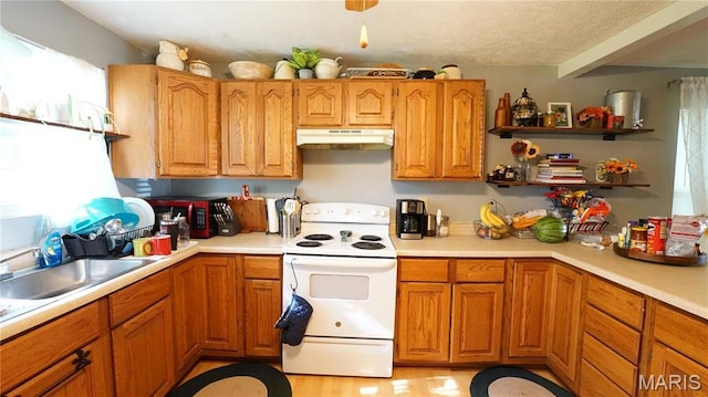 811 N Catalpa St, Dexter, MO 63841 - kitchen featuring electric range, under cabinet range hood, light countertops, brown cabinets, and a textured ceiling