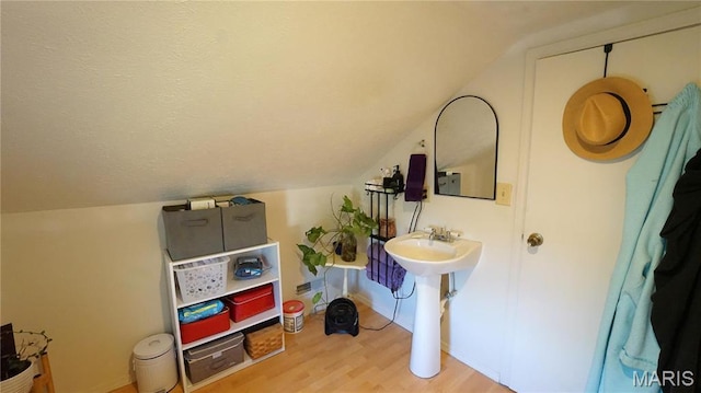 811 N Catalpa St, Dexter, MO 63841 - bathroom with wood finished floors, lofted ceiling, a sink, and baseboards