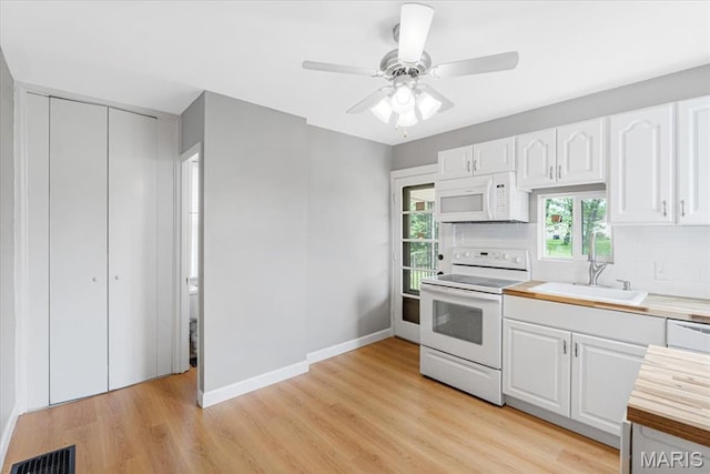 1522 S Elm Ave, Saint Louis, MO 63119 - kitchen with white appliances, a sink, light countertops, white cabinets, and tasteful backsplash