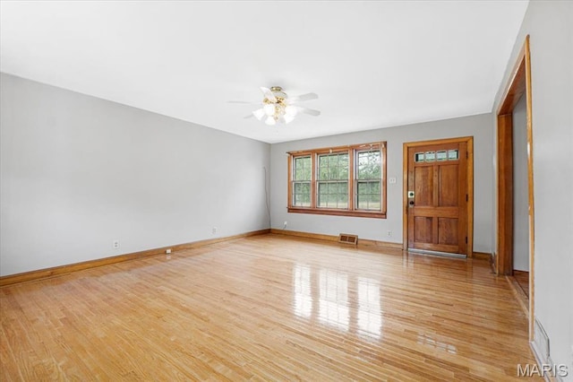 1522 S Elm Ave, Saint Louis, MO 63119 - unfurnished living room featuring light wood finished floors, baseboards, and a ceiling fan