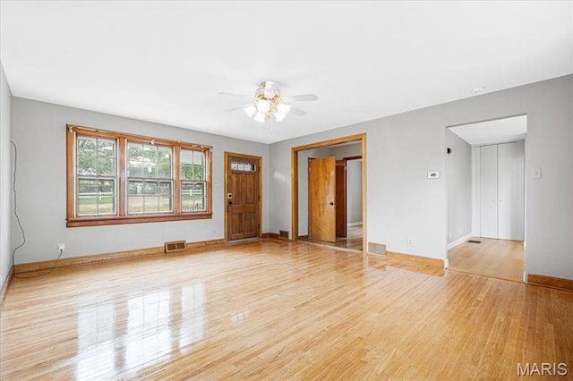 1522 S Elm Ave, Saint Louis, MO 63119 - unfurnished living room featuring light wood-type flooring, baseboards, and ceiling fan