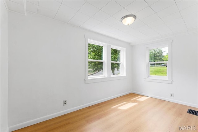 1522 S Elm Ave, Saint Louis, MO 63119 - unfurnished room with healthy amount of natural light, wood finished floors, and baseboards