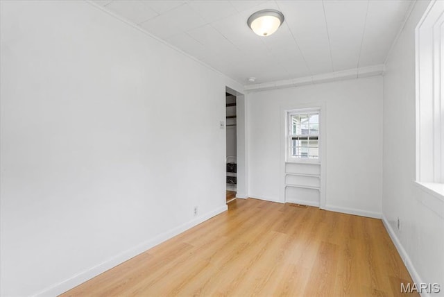 1522 S Elm Ave, Saint Louis, MO 63119 - unfurnished room featuring light wood-type flooring, crown molding, and baseboards