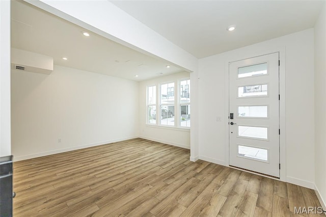 entrance foyer featuring light wood finished floors, baseboards, and recessed lighting