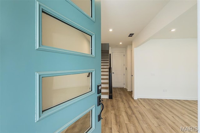 hallway with light wood-type flooring, recessed lighting, and baseboards