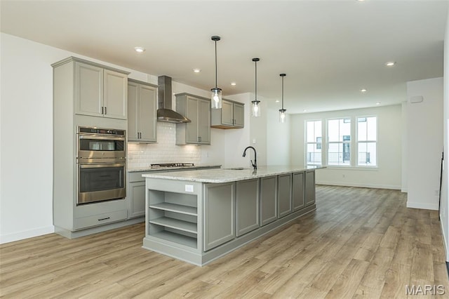 kitchen with gray cabinets, wall chimney range hood, open shelves, and recessed lighting