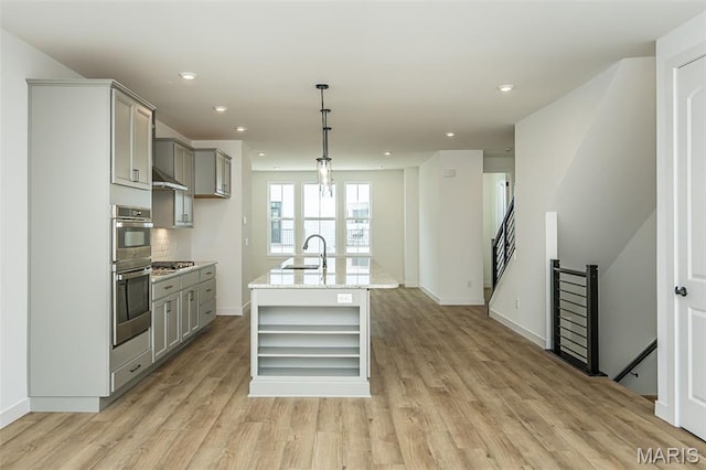 kitchen with a sink, gray cabinets, open shelves, light wood finished floors, and recessed lighting