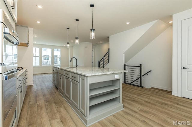 kitchen with open shelves, a sink, gray cabinets, light wood finished floors, and recessed lighting