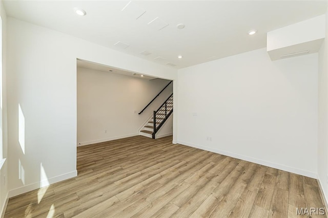 unfurnished room with light wood-type flooring, stairway, recessed lighting, and baseboards