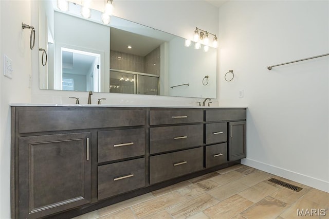 8924 Gateway Cir, Richmond Heights, MO 63144 - full bath with a shower stall, double vanity, wood tiled floors, and baseboards