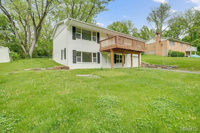 back of property featuring a deck and a lawn