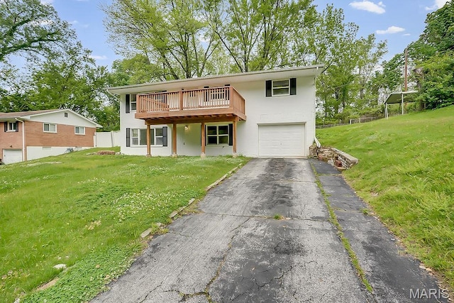 view of front of house with driveway, a garage, a front yard, and stucco siding