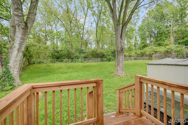 wooden deck with view of wooded area