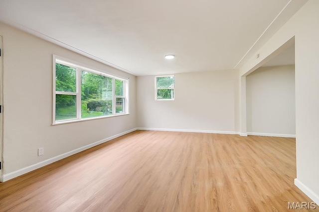 spare room with light wood finished floors and baseboards