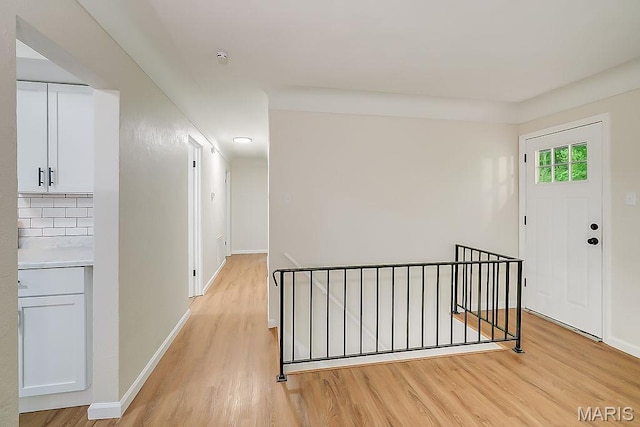 entryway with light wood-style floors and baseboards
