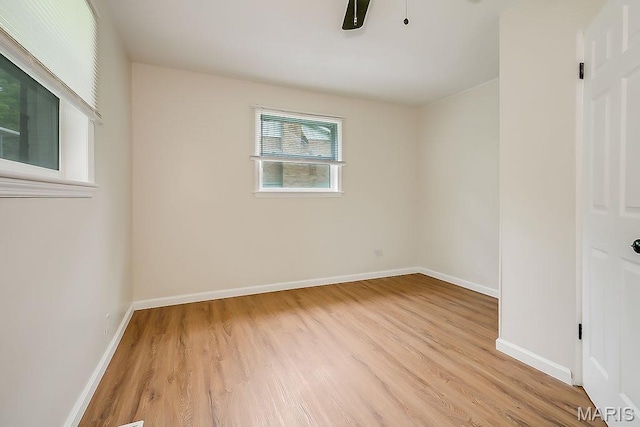 unfurnished room featuring light wood-type flooring, baseboards, and a ceiling fan