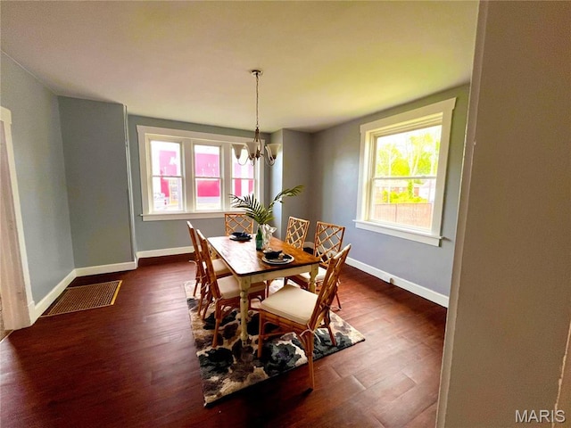 dining room featuring baseboards, a chandelier, and dark wood-type flooring