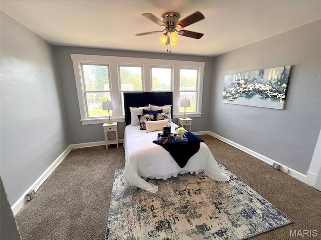 carpeted bedroom with baseboards and a ceiling fan