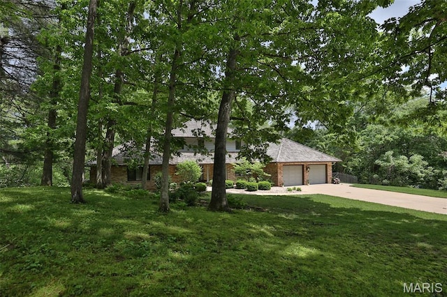 1989 Dogwood Trl, Collinsville, IL 62234 - obstructed view of property featuring driveway, a front lawn, a garage, and brick siding