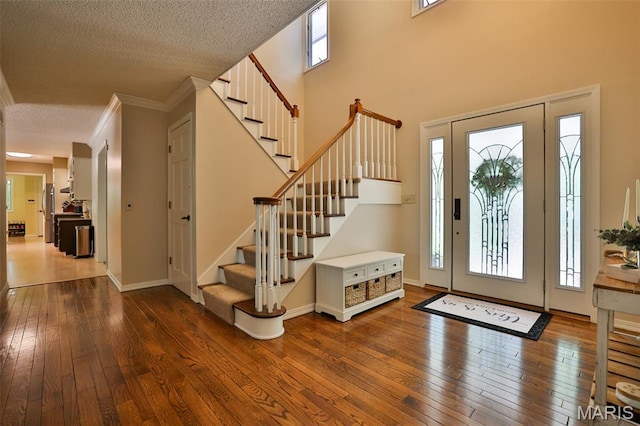 1989 Dogwood Trl, Collinsville, IL 62234 - foyer entrance with wood-type flooring, stairway, ornamental molding, a textured ceiling, and baseboards