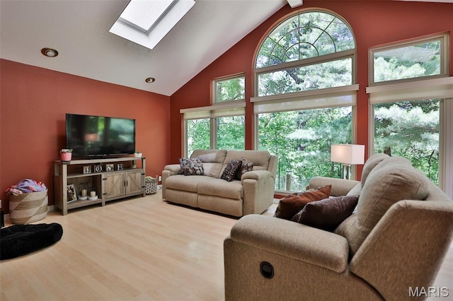 1989 Dogwood Trl, Collinsville, IL 62234 - living area with a skylight, plenty of natural light, high vaulted ceiling, and wood finished floors