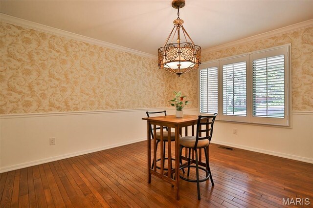 1989 Dogwood Trl, Collinsville, IL 62234 - dining space featuring wainscoting, a chandelier, dark wood-type flooring, wallpapered walls, and crown molding