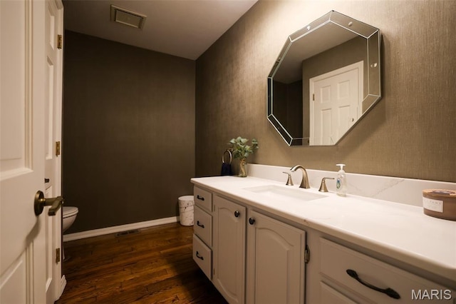 1989 Dogwood Trl, Collinsville, IL 62234 - bathroom featuring wood finished floors, toilet, vanity, and baseboards