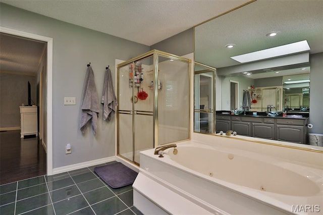 1989 Dogwood Trl, Collinsville, IL 62234 - bathroom featuring a skylight, a shower stall, a jetted tub, vanity, and tile patterned floors