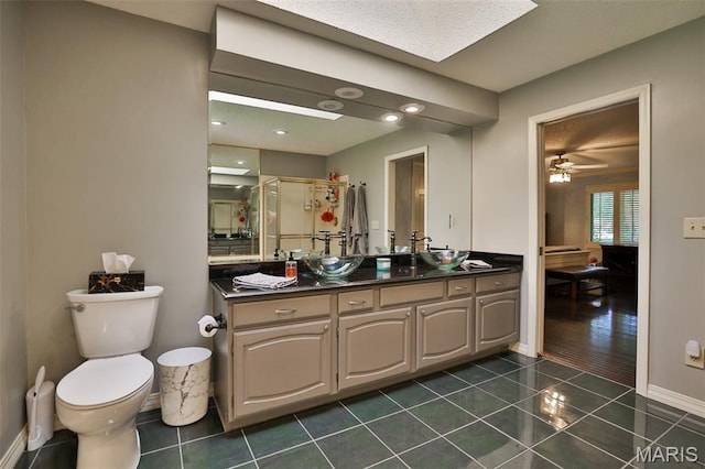 1989 Dogwood Trl, Collinsville, IL 62234 - bathroom featuring vanity, toilet, tile patterned flooring, a stall shower, and baseboards
