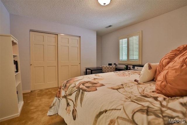 1989 Dogwood Trl, Collinsville, IL 62234 - carpeted bedroom featuring a closet and a textured ceiling