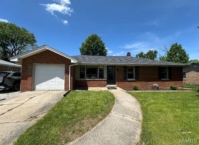 single story home with brick siding, a garage, concrete driveway, and a front lawn