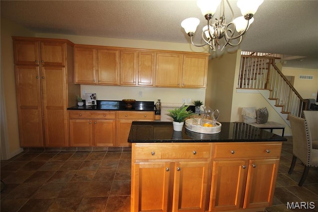 kitchen with a chandelier, hanging light fixtures, brown cabinets, and a center island