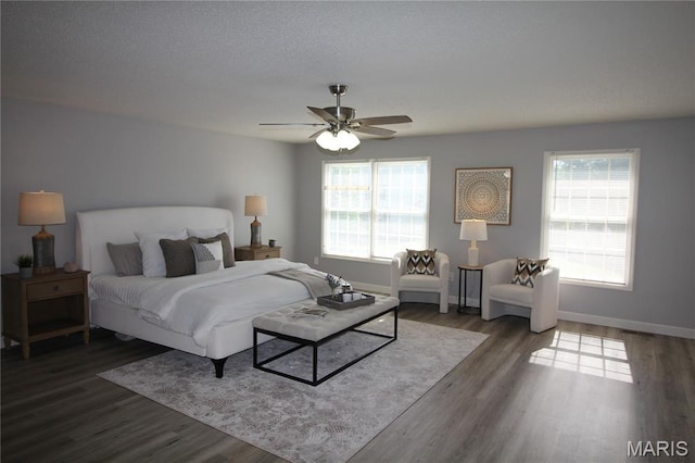bedroom with wood finished floors, baseboards, and a ceiling fan