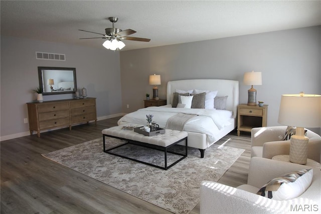 bedroom featuring wood finished floors, baseboards, and ceiling fan