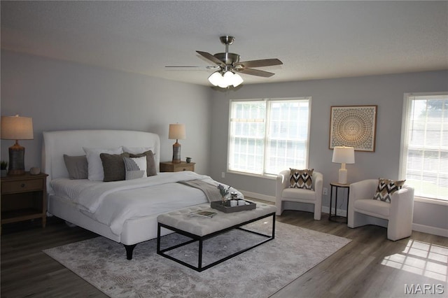 bedroom featuring wood finished floors, baseboards, and a ceiling fan