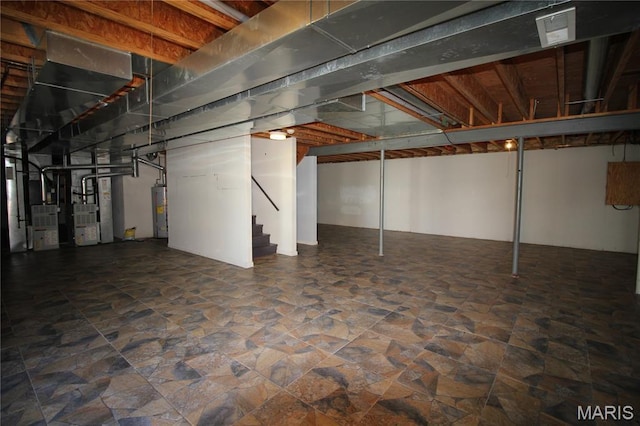 basement featuring water heater, stairs, stone finish floors, and heating unit