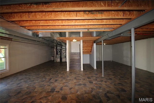 basement featuring dark stone finish flooring and stairs