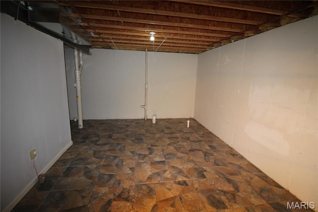 unfinished basement featuring dark stone finish floors