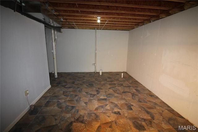 unfinished below grade area with dark stone finish flooring
