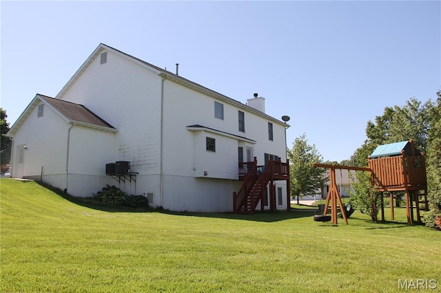 back of house with a playground, stairway, a yard, and a chimney