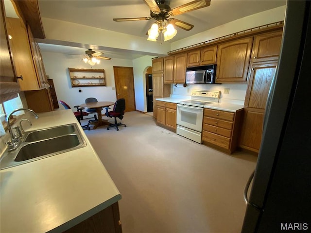 401 Edinger Rd, Wentzville, MO 63385 - kitchen with white range with electric stovetop, stainless steel microwave, a sink, a ceiling fan, and freestanding refrigerator