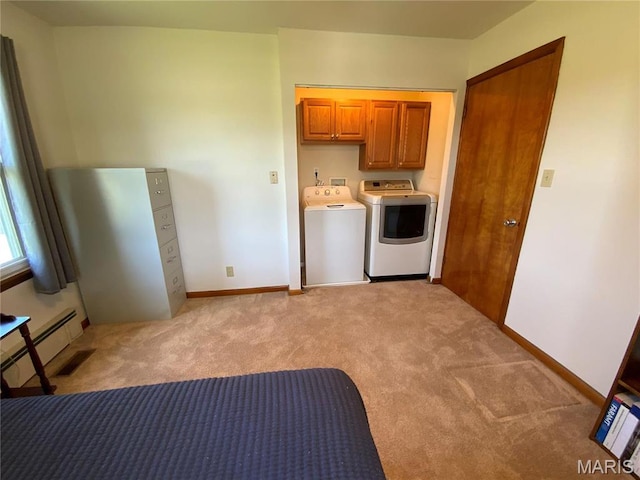 401 Edinger Rd, Wentzville, MO 63385 - laundry room featuring washer and dryer, light colored carpet, cabinet space, a baseboard heating unit, and baseboards