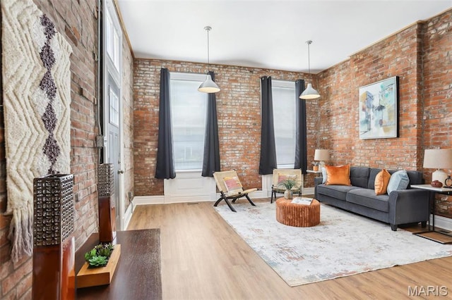 2713 Utah St, Saint Louis, MO 63118 - living area with wood finished floors, brick wall, and baseboards