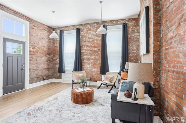 2713 Utah St, Saint Louis, MO 63118 - sitting room with wood finished floors, brick wall, and baseboards