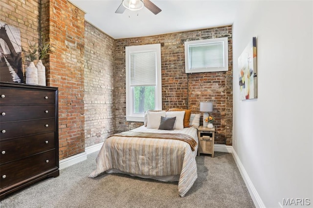 2713 Utah St, Saint Louis, MO 63118 - carpeted bedroom featuring baseboards, brick wall, and a ceiling fan