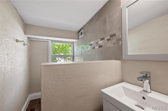 400 Main St, Waynesville, MO 65583 - bathroom with a sink, wood finished floors, and tiled shower