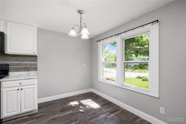 400 Main St, Waynesville, MO 65583 - unfurnished dining area featuring a chandelier, baseboards, and dark wood-style flooring
